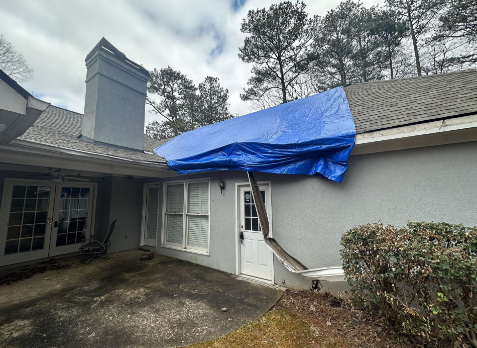 Image of a residential roof in Powder Springs with storm damages