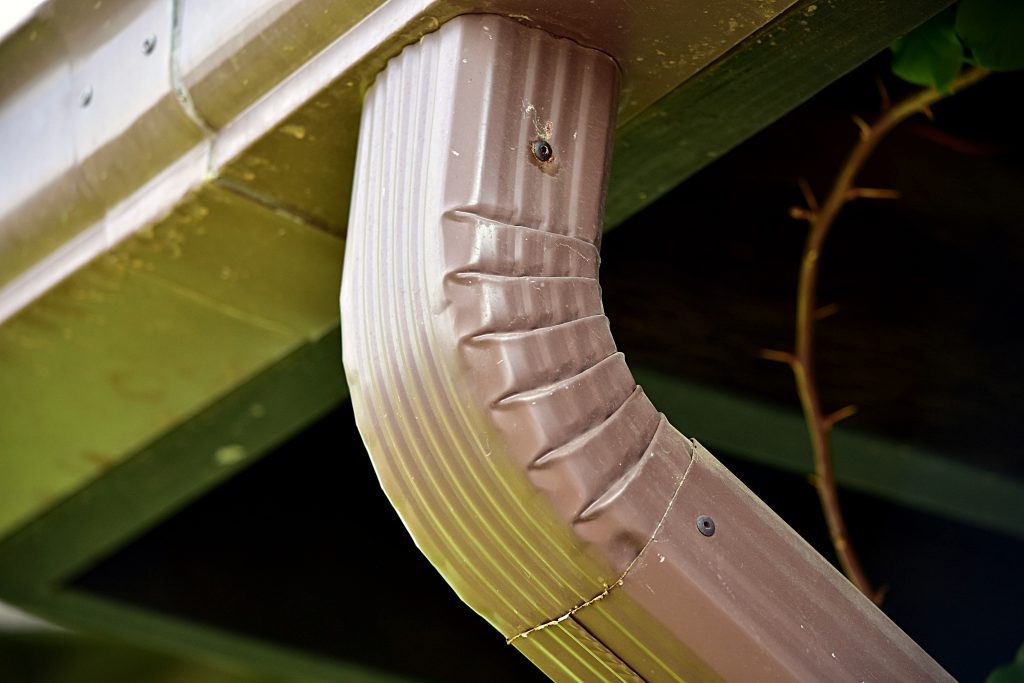 Upclose photo of a downspout on a home