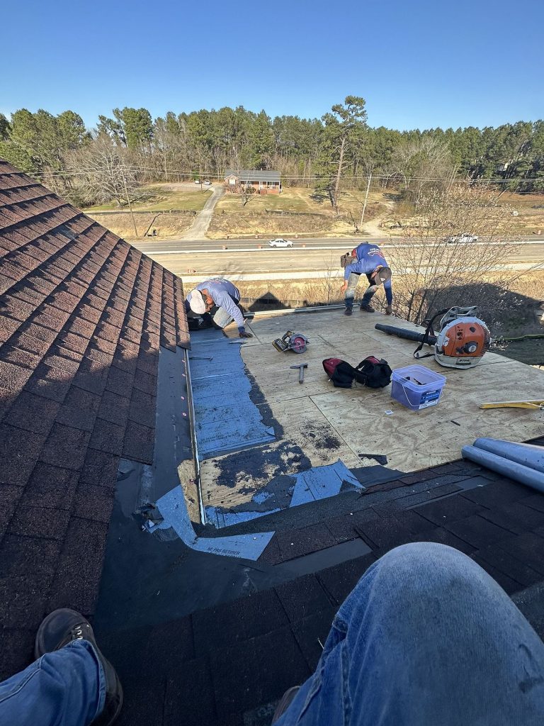 Image of rooftop repairs being made by roofers