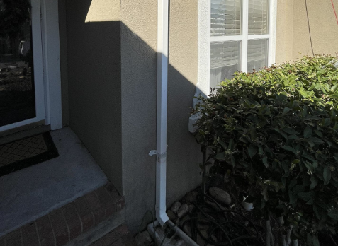 Close-up of white gutter downspouts