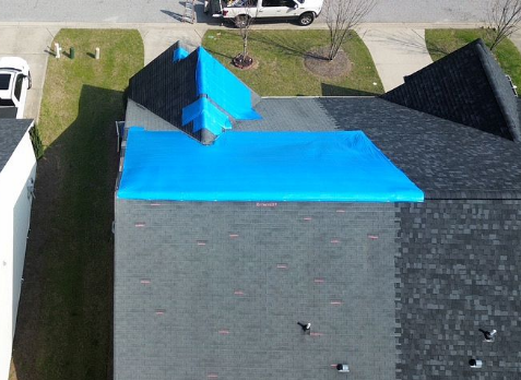 Aerial photo of roof with storm damage after hail storm with drone