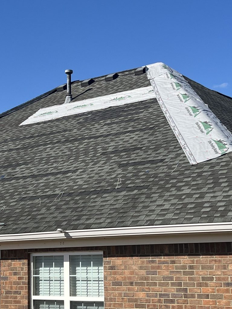 Photo of hail damage roofing contractors inspecting a roof from ground after hail storm.