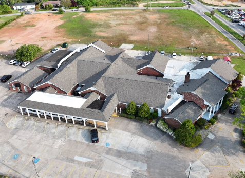 Drone Image of a gray commercial shingle roof after commercial roof replacement