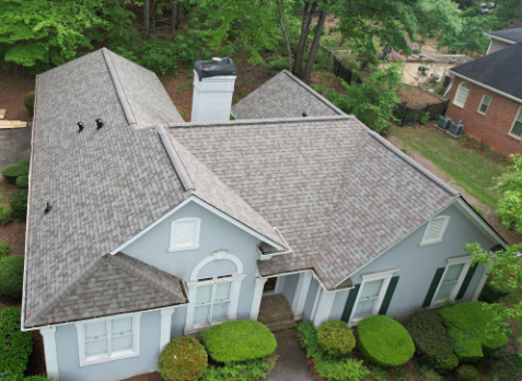 Image of residential blue house with a new gray shingle roof in Hoover Alabama