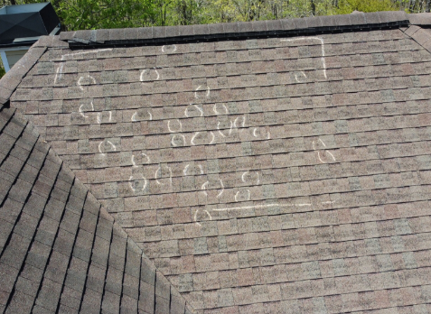 Photo of roof inspection of a roof after hail storm