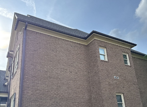 Image of Brown Gutters newly installed on a brick house
