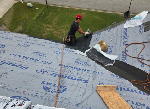 Roofers on a house with during a roof replacement