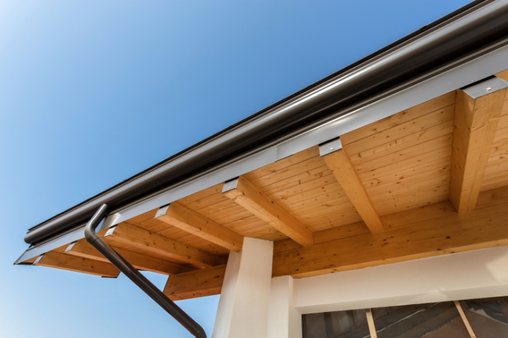 Upclose photo looking up at new black Gutters on a home