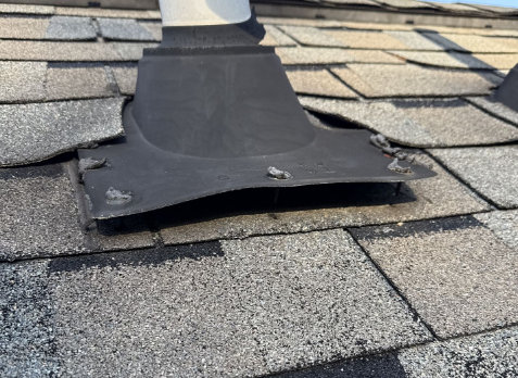 Upclose image of a damaged vent on a roof needing general roof repair