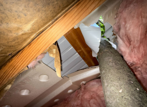 Upclose image looking up at a residential roof form inside a home in Woodstock Georgia after storm damages needing repair