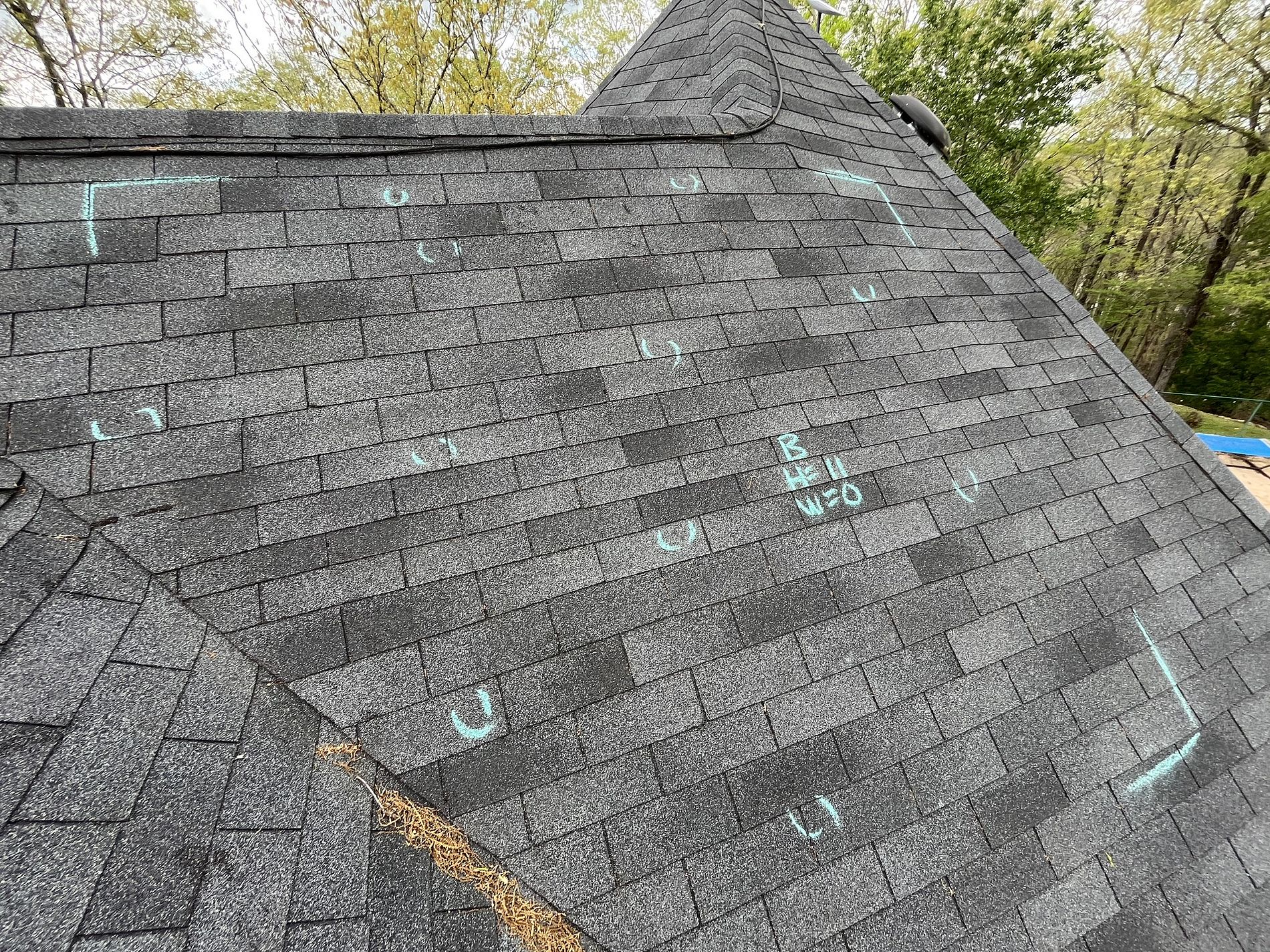 Roof Hail Damage photo of gray shingles with hail damage on roof
