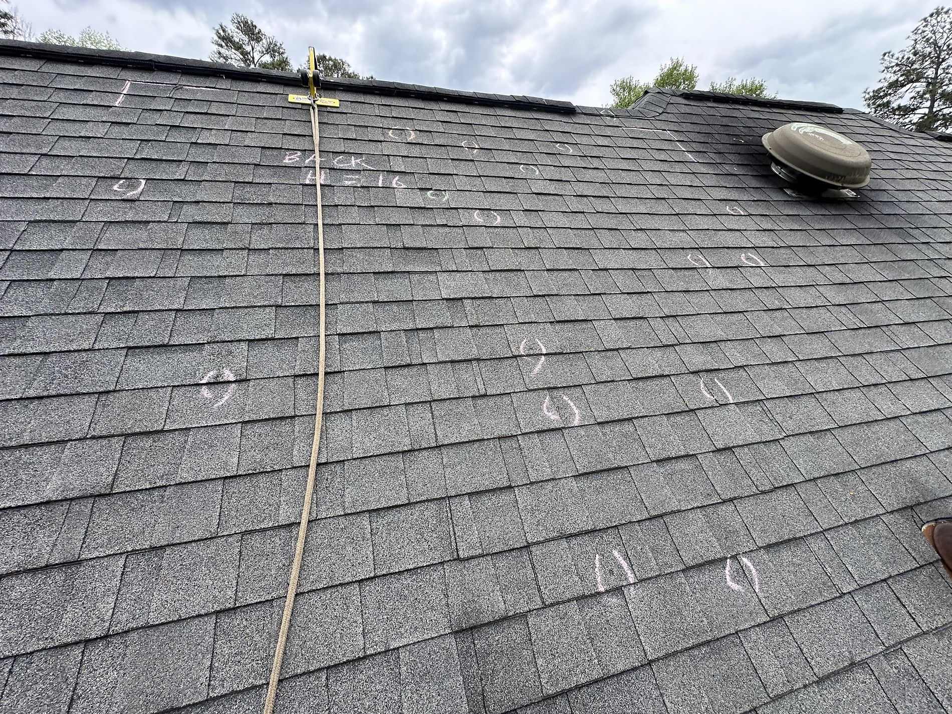 Photo of roof inspection of a roof with roof hail damage on roof