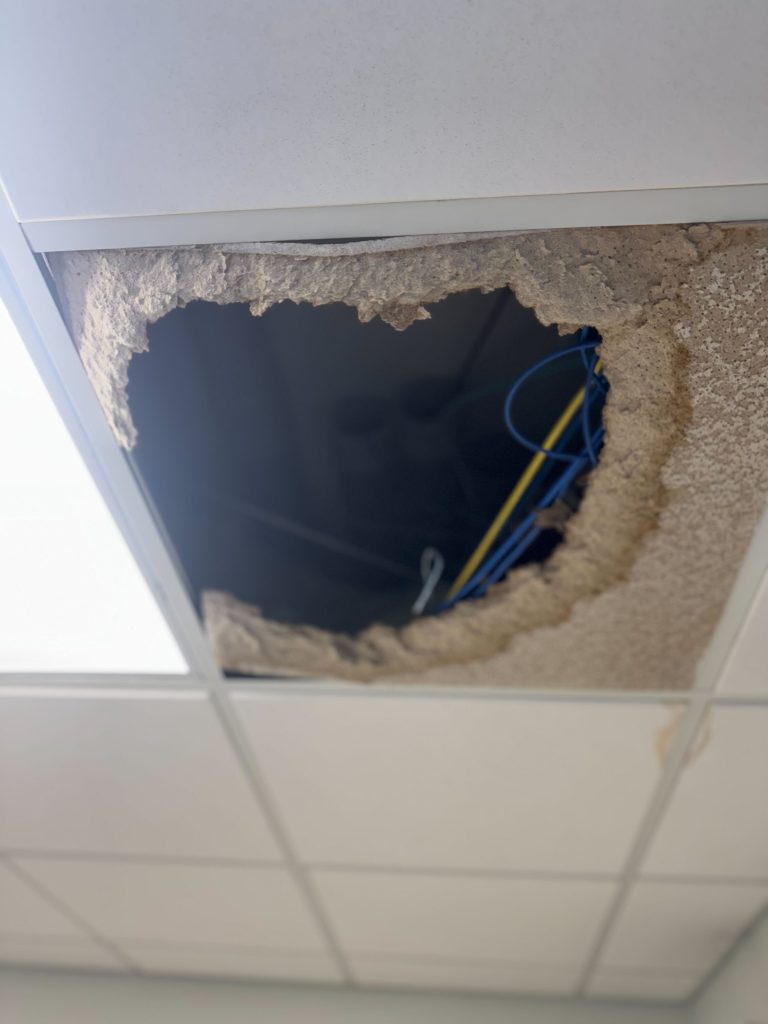 Ceiling tile inside home that caved through do to roof leaking.