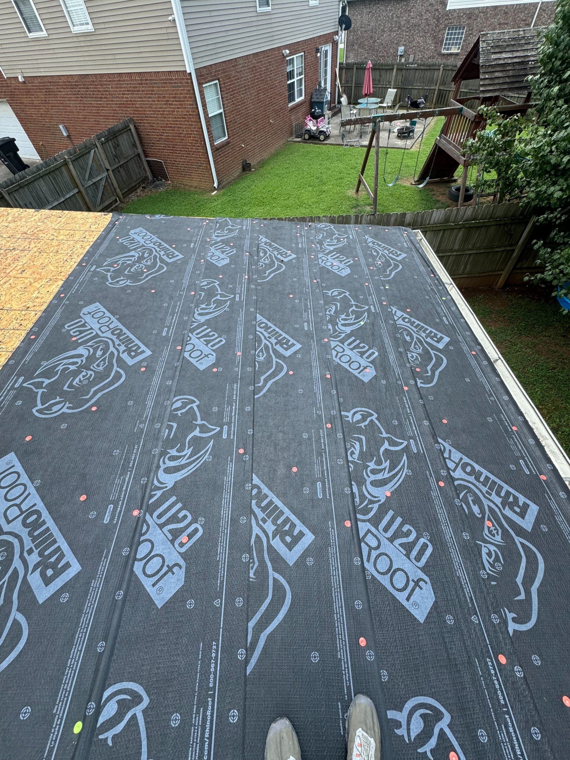 Closeup image of a roof in the process of installing new shingles