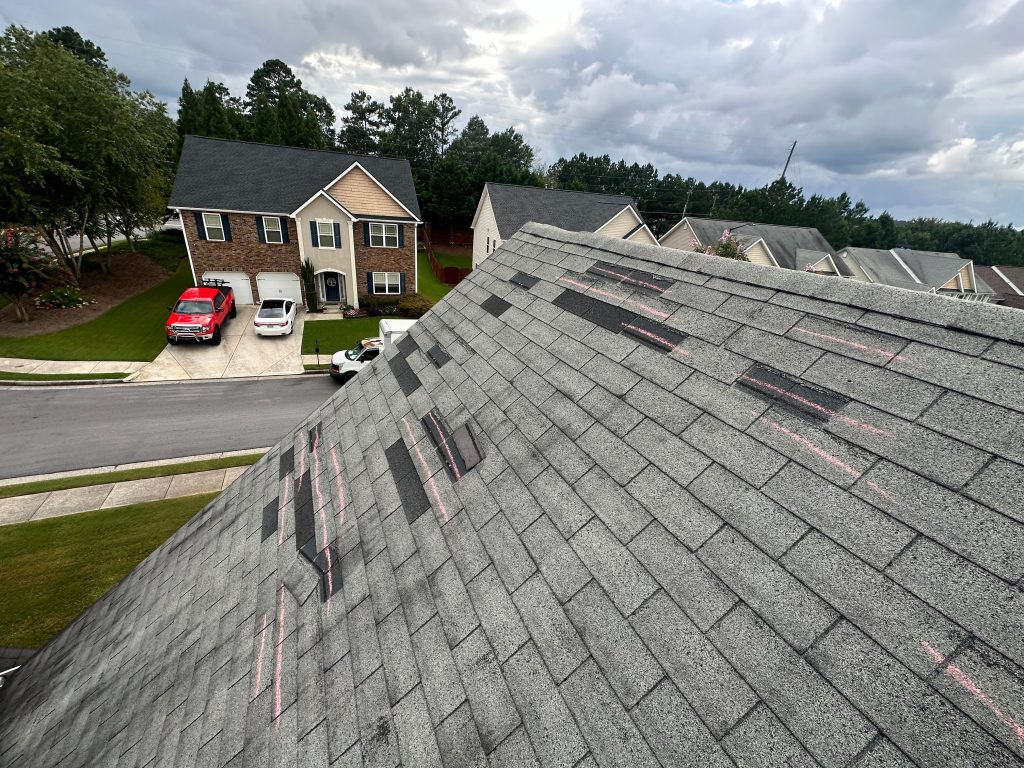 Image of a roof with missing shingles that led to roof leaking and water damage.