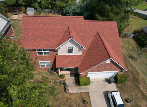 Drone Image of a house with newly installed red shingled roof.