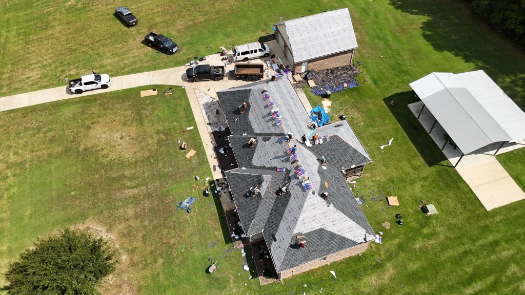 Drone image of top roof contractors replacing a roof