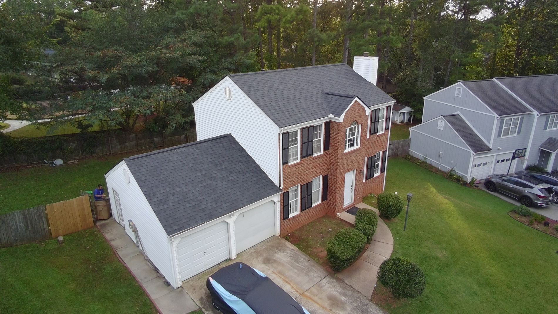 Image of a new gray asphalt shingled roof replacement on a house.