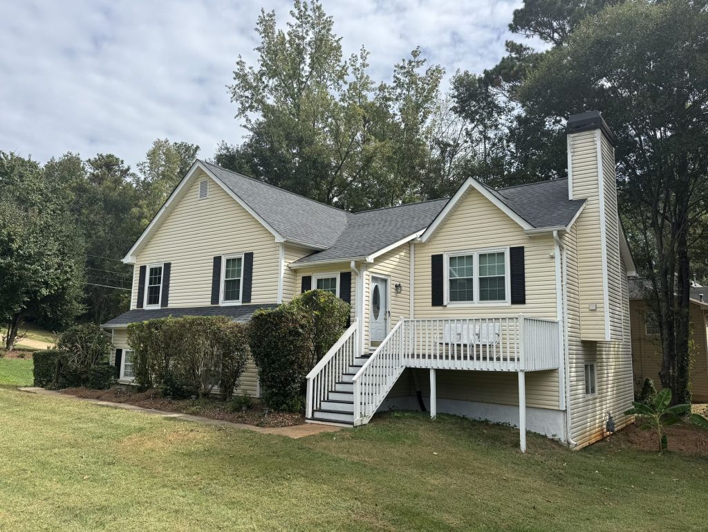 Image of a new gray asphalt shingled roof replacement on a house.