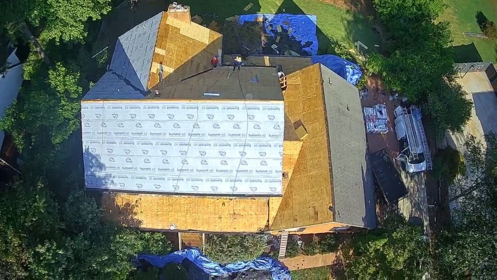 Image of a roof being replaced after wind damage