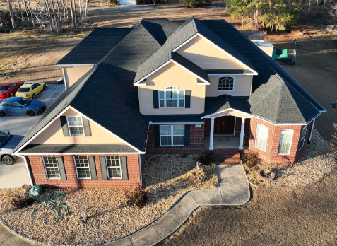Image of a brick house with a new residential roofing in Anniston