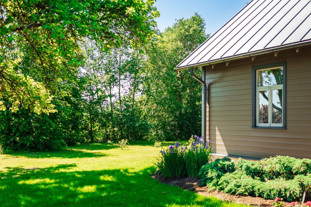 Wooden house with a metal roof in the countryside.