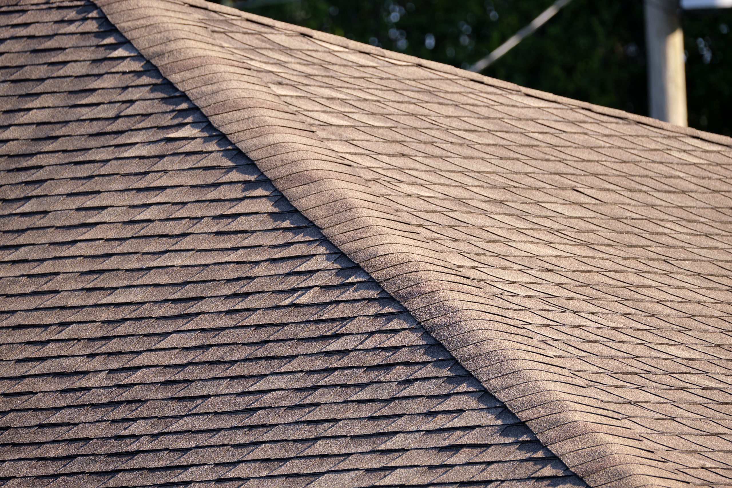 Closeup of house roof top covered with asphalt shingles